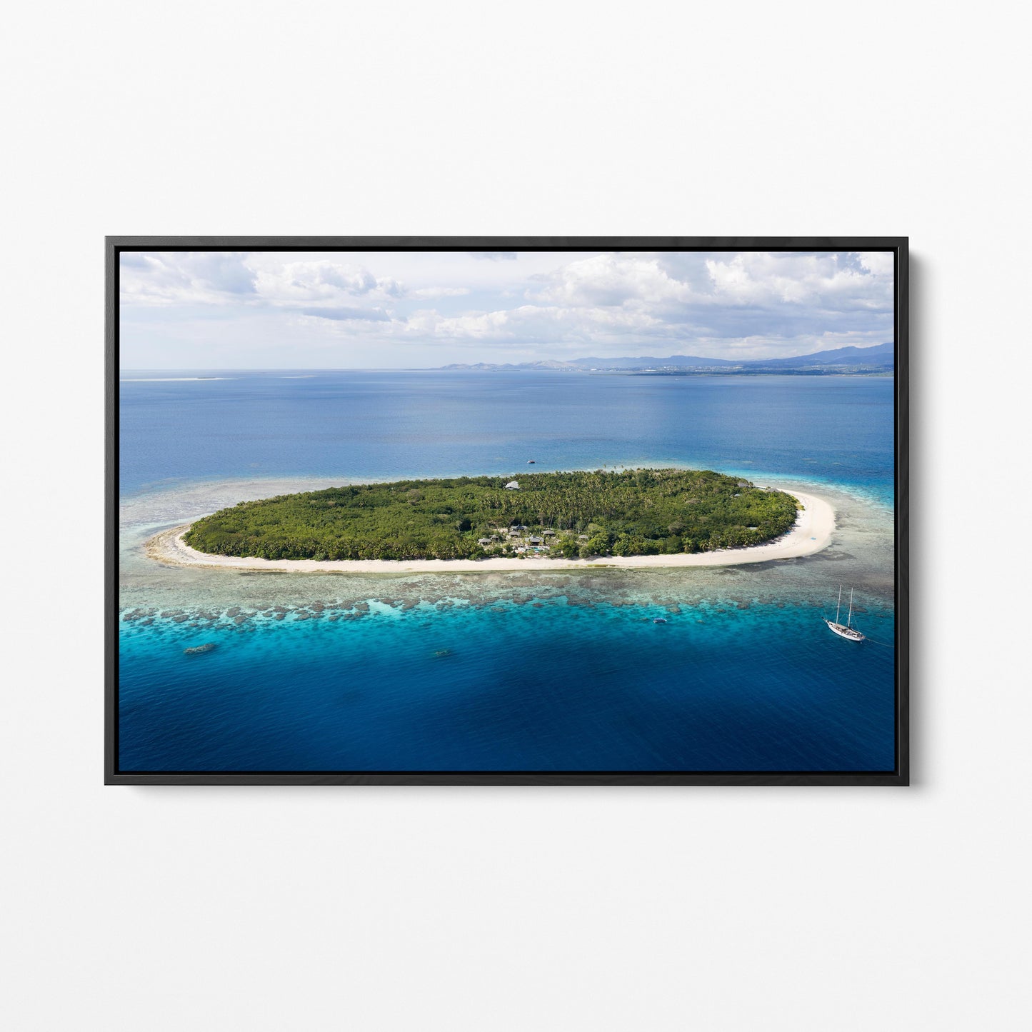 The whole of Serenity Island in Fiji from the air, in a black frame