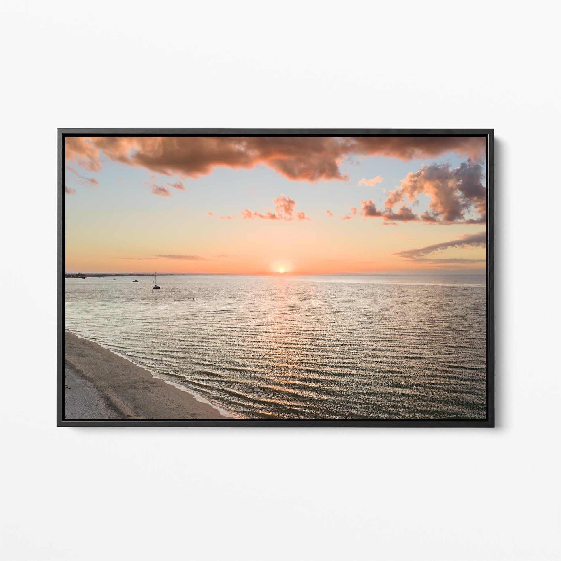 Black framed canvas print of the sun setting over Geographe Bay at Busselton, Western Australia