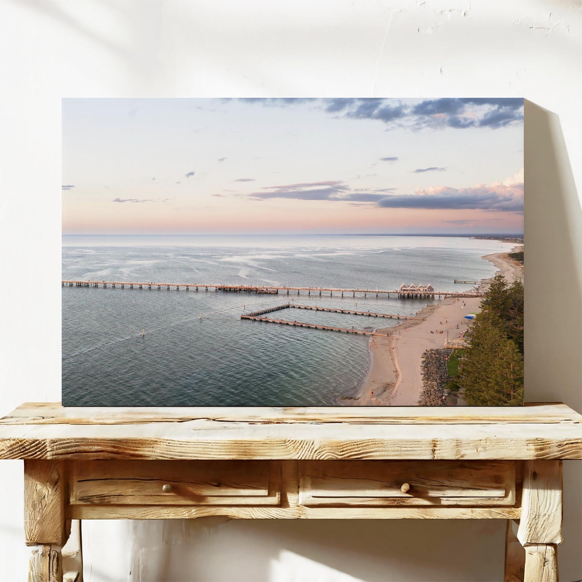 Stretched canvas print of Busselton Jetty across Geographe Bay at sunset, leaning on a timber bench
