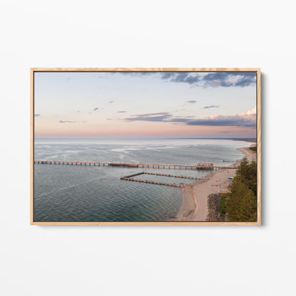 Oak framed canvas print of Busselton Jetty across Geographe Bay at sunset, Western Australia