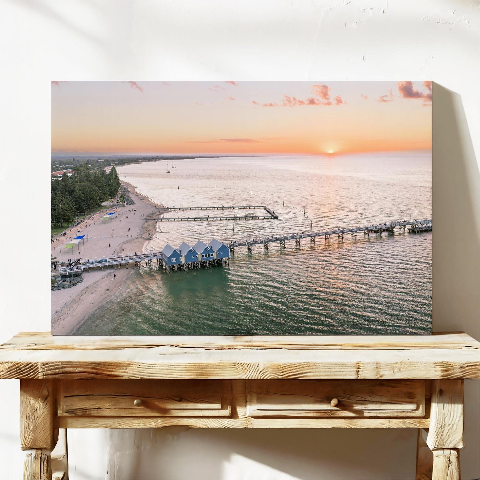 Stretched canvas print of Busselton Jetty and the blue boat sheds at sunset, on a timber bench