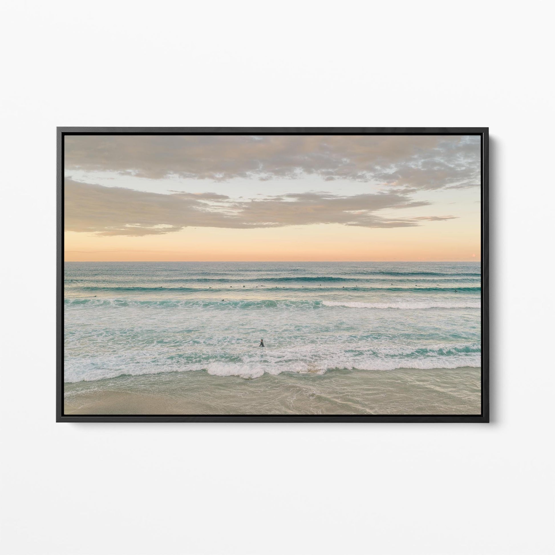Black framed canvas print of surfers in the lineup at Duranbah Beach at sunset, New South Wales