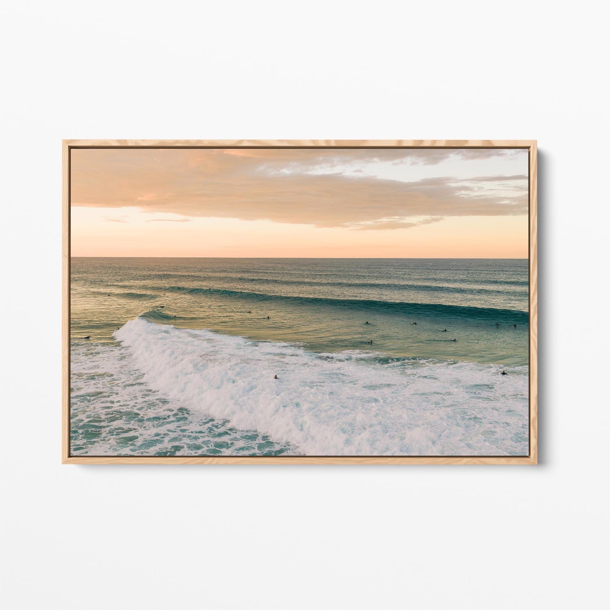 Oak framed canvas print of a long line of swell at Duranbah Beach at sunset, New South Wales