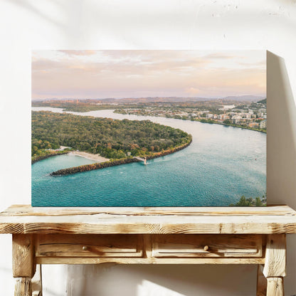 Stretched canvas print of the river mouth beside Duranbah Beach at sunset, leaning on a timber bench