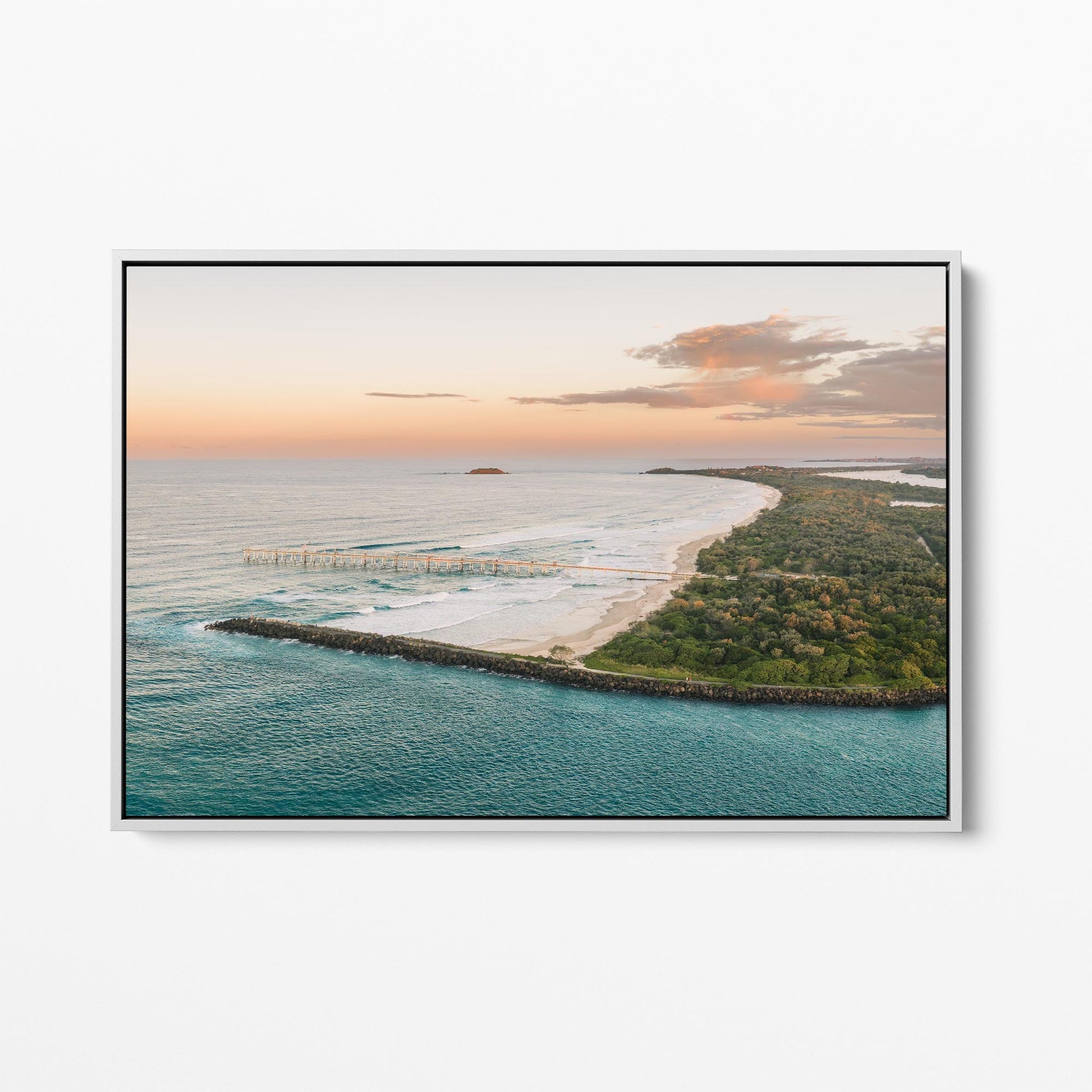 White framed canvas print of the headland and curving beach at Duranbah at sunset, New South Wales