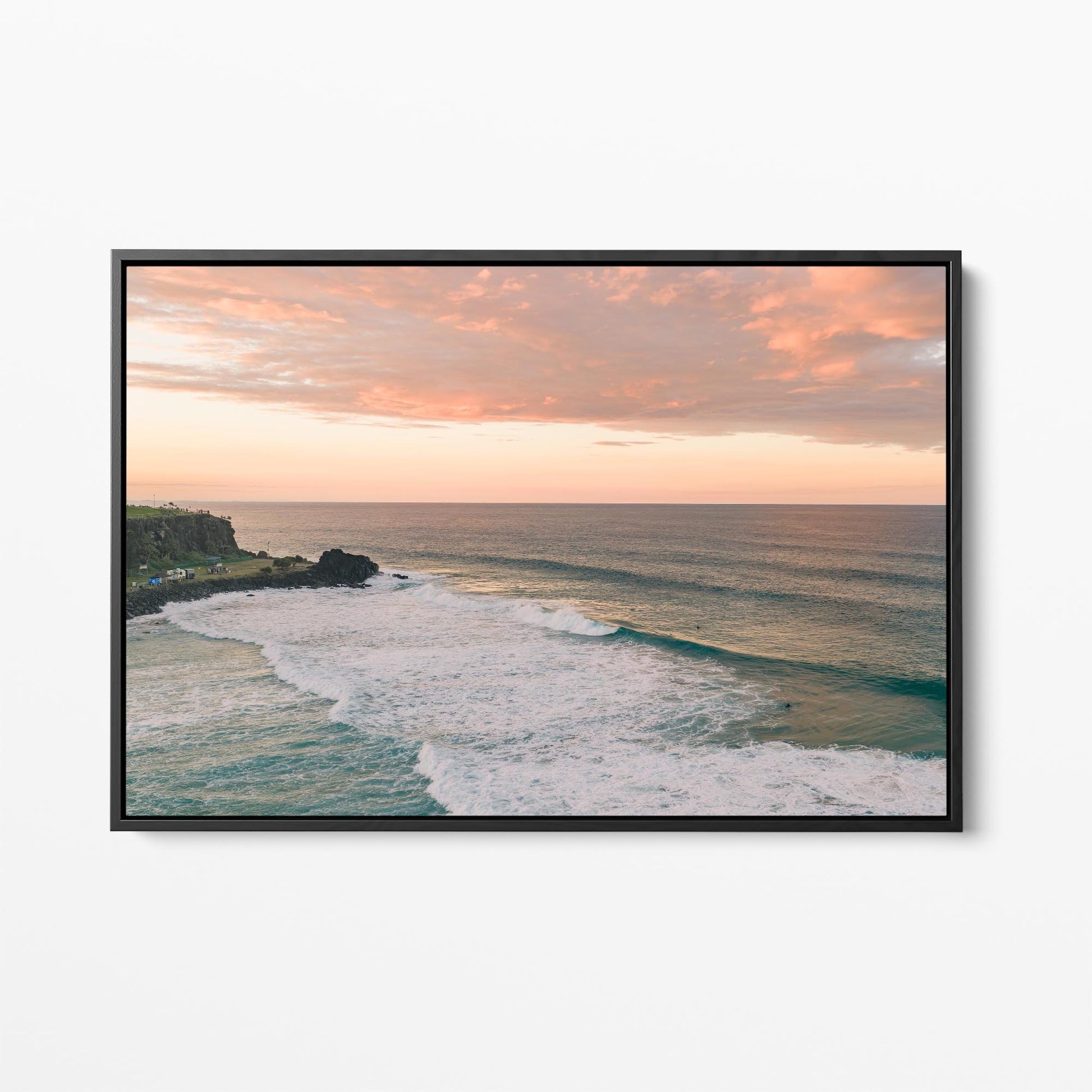 Black framed canvas print of pink sunset cloud over the point at Duranbah, New South Wales