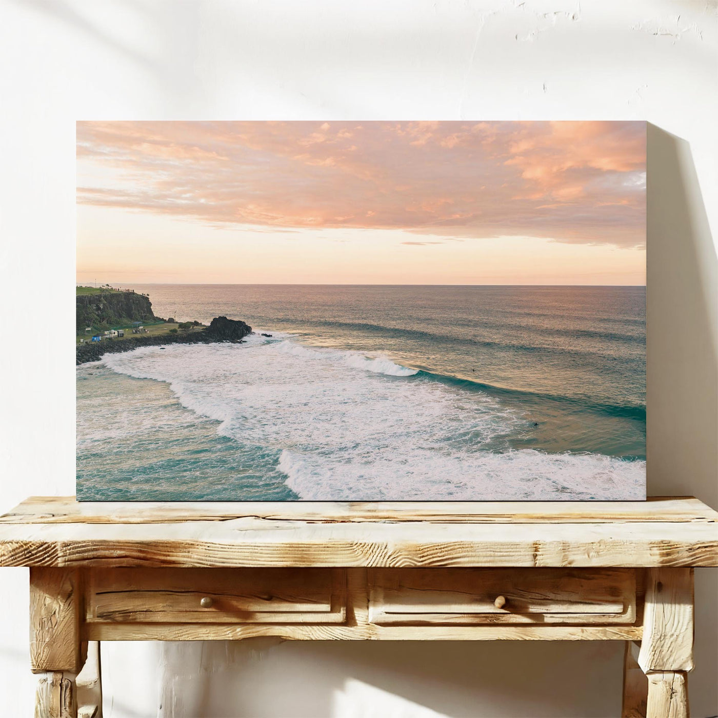 Stretched canvas print of pink sunset cloud over the point at Duranbah, leaning on a timber bench