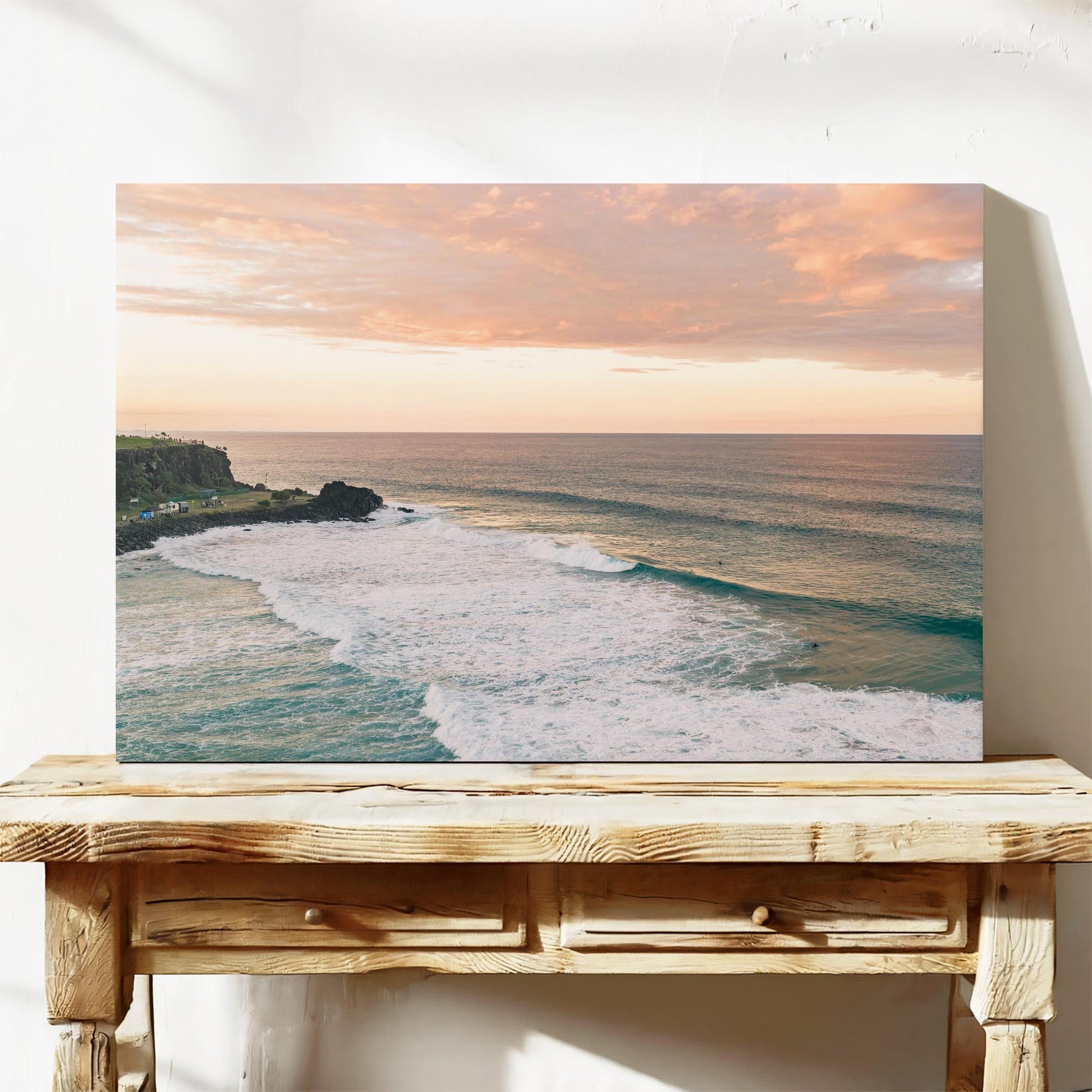 Stretched canvas print of pink sunset cloud over the point at Duranbah, leaning on a timber bench