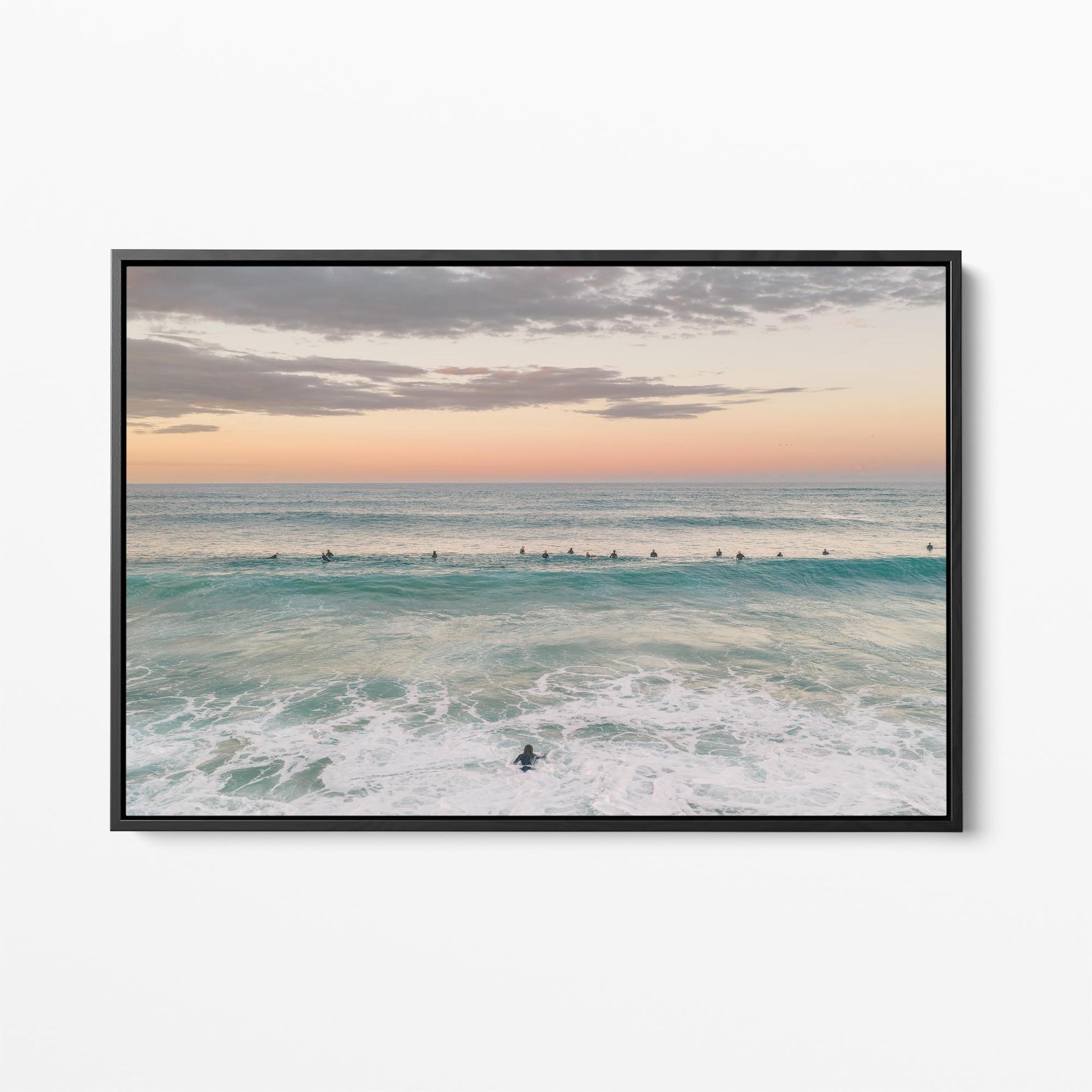 Black framed canvas print of the surfing lineup at Duranbah Beach at sunset, New South Wales