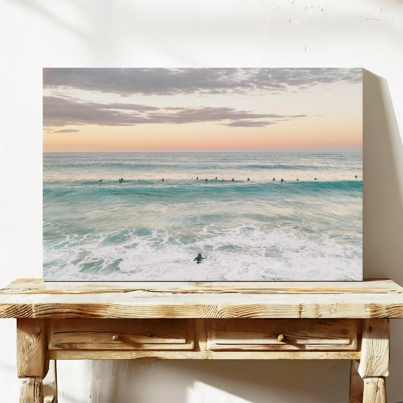 Stretched canvas print of the surfing lineup at Duranbah Beach at sunset, leaning on a timber bench