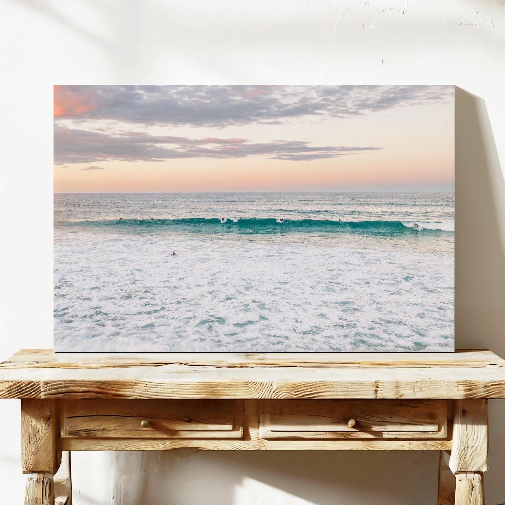 Stretched canvas print of a lone surfer at Duranbah Beach at sunset, leaning on a timber bench