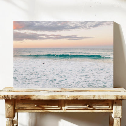 Stretched canvas print of a lone surfer at Duranbah Beach at sunset, leaning on a timber bench